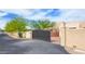 Gated entrance with desert landscaping and privacy wall, leading to a well-maintained home at 29619 N 142Nd Pl, Scottsdale, AZ 85262