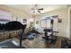 Home gym with various equipment, including a treadmill, weight machine, and exercise bike, for a complete workout experience at 29619 N 142Nd Pl, Scottsdale, AZ 85262