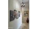 This hallway features modern light fixture and artwork at 29619 N 142Nd Pl, Scottsdale, AZ 85262