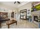 Spacious living area with stone fireplace, tile flooring, and open to kitchen and other living spaces at 29619 N 142Nd Pl, Scottsdale, AZ 85262