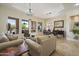 Inviting living room featuring stylish furnishings, tile flooring, and abundant natural light from large windows at 29619 N 142Nd Pl, Scottsdale, AZ 85262