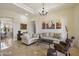 Elegant living room showcasing neutral colors, tasteful decor, and comfortable seating arrangement on tile floor at 29619 N 142Nd Pl, Scottsdale, AZ 85262