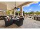 Outdoor patio with comfortable seating, fire pit, and a view of the pool, perfect for entertaining at 29619 N 142Nd Pl, Scottsdale, AZ 85262
