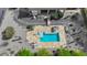 Aerial view of a private pool with a stone tile patio, desert landscaping, and outdoor seating areas at 29619 N 142Nd Pl, Scottsdale, AZ 85262