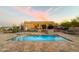 Backyard pool with tiled deck and desert landscaping at sunset at 29619 N 142Nd Pl, Scottsdale, AZ 85262
