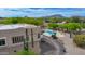 Aerial view of backyard pool, desert landscaping, gravel path, and mountain views on a bright, sunny day at 29619 N 142Nd Pl, Scottsdale, AZ 85262