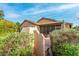 Cozy screened-in back patio with bench, lush landscaping, and neutral colors, perfect for outdoor relaxation and entertaining at 3038 W Trapanotto Rd, Phoenix, AZ 85086