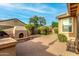 Outdoor kitchen, fireplace and seating on a brick-paved area at 3038 W Trapanotto Rd, Phoenix, AZ 85086