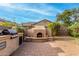 Backyard outdoor fireplace and kitchen with brick-paved area at 3038 W Trapanotto Rd, Phoenix, AZ 85086