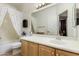 Bright bathroom with a large mirror, wood cabinet and a bathtub at 3038 W Trapanotto Rd, Phoenix, AZ 85086