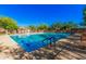 Large community swimming pool with crystal clear blue water, lounge chairs, and shade structures, great for summer fun at 3038 W Trapanotto Rd, Phoenix, AZ 85086