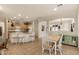 Bright dining area featuring tile floors and an open view to the kitchen with bar seating at 3038 W Trapanotto Rd, Phoenix, AZ 85086