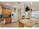 Bright kitchen featuring a spacious granite island, stainless steel appliances, and natural wood cabinetry at 3038 W Trapanotto Rd, Phoenix, AZ 85086