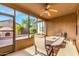 Covered patio featuring tiled flooring, ceiling fan, and glass windows at 3038 W Trapanotto Rd, Phoenix, AZ 85086