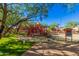 Community playground featuring modern play structures and swings under a shady tree, perfect for outdoor fun at 3038 W Trapanotto Rd, Phoenix, AZ 85086