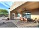 Covered outdoor patio featuring a tile floor, ceiling fan, and dining set at 30600 N Pima Rd # 81, Scottsdale, AZ 85266