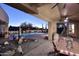 A backyard area with a covered patio, pool, water feature, and desert landscaping for outdoor enjoyment at 30600 N Pima Rd # 81, Scottsdale, AZ 85266