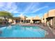Stunning home exterior overlooking pool with stone accents, desert plants, and blue skies at 30600 N Pima Rd # 81, Scottsdale, AZ 85266