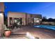 Outdoor backyard space with pool, fire pit, desert landscaping, and exterior view of the house at 30600 N Pima Rd # 81, Scottsdale, AZ 85266