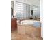 Bathroom showcasing a soaking tub with tile surround and a glass block window for privacy at 30600 N Pima Rd # 81, Scottsdale, AZ 85266