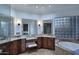 Bathroom featuring vanity, makeup area, soaking tub, with block glass window and tile flooring at 30600 N Pima Rd # 81, Scottsdale, AZ 85266