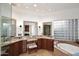 Bright bathroom has double vanity, seated makeup area, soaking tub, and a block glass window at 30600 N Pima Rd # 81, Scottsdale, AZ 85266
