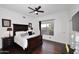 Beautiful bedroom with a large window, dark wood floors and a ceiling fan at 30600 N Pima Rd # 81, Scottsdale, AZ 85266