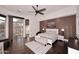 Bright bedroom features a ceiling fan, hardwood floors, and access to the outdoor pool and patio at 30600 N Pima Rd # 81, Scottsdale, AZ 85266