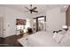 This bedroom includes a ceiling fan, carpeted floors and views of the home's backyard at 30600 N Pima Rd # 81, Scottsdale, AZ 85266