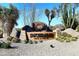 Community entrance featuring desert landscaping, signage, and a picturesque rock formation at 30600 N Pima Rd # 81, Scottsdale, AZ 85266