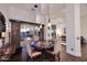Elegant dining room featuring decorative lighting and access to an outdoor living space with a fire pit at 30600 N Pima Rd # 81, Scottsdale, AZ 85266