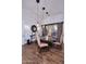 Beautiful dining room with stylish lighting fixtures, a round wooden table, and hardwood floors at 30600 N Pima Rd # 81, Scottsdale, AZ 85266