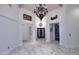 Grand foyer with marble floors, elegant chandelier, and high ceilings creates a striking first impression at 30600 N Pima Rd # 81, Scottsdale, AZ 85266
