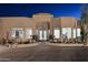 Inviting front entrance with desert landscaping and a unique stone-accented facade under the night sky at 30600 N Pima Rd # 81, Scottsdale, AZ 85266