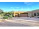 Large home with a circular driveway and a two-car garage surrounded by desert landscaping at 30600 N Pima Rd # 81, Scottsdale, AZ 85266