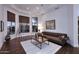 Cozy living room featuring a bay window, hardwood floors, and a stylish leather sofa at 30600 N Pima Rd # 81, Scottsdale, AZ 85266