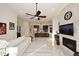 The open concept living room features a stone fireplace and views into the kitchen at 30600 N Pima Rd # 81, Scottsdale, AZ 85266