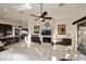 Bright living room features a stone fireplace, ceiling fan, and marble flooring at 30600 N Pima Rd # 81, Scottsdale, AZ 85266