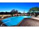 Tranquil pool area with brick patio, desert plants, and cozy seating under the evening sky at 30600 N Pima Rd # 81, Scottsdale, AZ 85266