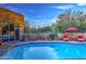 Beautiful pool area featuring a pool, desert landscape and cozy lounge chairs with red accents at 30600 N Pima Rd # 81, Scottsdale, AZ 85266