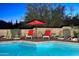 Relaxing poolside seating with red umbrella, desert landscaping, and brick pavers at 30600 N Pima Rd # 81, Scottsdale, AZ 85266