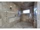 Custom tile shower with shower head, body jets, handheld sprayer, bench, and grab bars at 30600 N Pima Rd # 81, Scottsdale, AZ 85266
