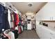 Large walk-in closet with custom shelving and plenty of storage space for shoes, clothes, and accessories at 30600 N Pima Rd # 81, Scottsdale, AZ 85266