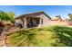 Landscaped backyard with covered patio, seating and grassy area at 3241 E Hampton Ln, Gilbert, AZ 85295