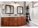 Elegant bathroom featuring a double vanity with granite countertops, modern fixtures, and a shower-tub combo at 3241 E Hampton Ln, Gilbert, AZ 85295