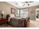 Cozy bedroom featuring a ceiling fan, natural light, and neutral tones, creating a serene and relaxing atmosphere at 3241 E Hampton Ln, Gilbert, AZ 85295