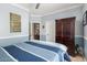 Bedroom featuring light blue walls, carpet, and a wooden wardrobe and dark wood trim at 3241 E Hampton Ln, Gilbert, AZ 85295