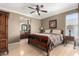 Comfortable bedroom featuring a ceiling fan, neutral color palette, and an en-suite bathroom for a relaxing retreat at 3241 E Hampton Ln, Gilbert, AZ 85295