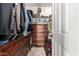 Walk-in closet featuring hanging clothes, shelving and drawers, and a fun lion's head at 3241 E Hampton Ln, Gilbert, AZ 85295