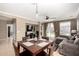 Well-lit dining room featuring a large wooden table, open layout, and seamless transition to the comfortable living area at 3241 E Hampton Ln, Gilbert, AZ 85295